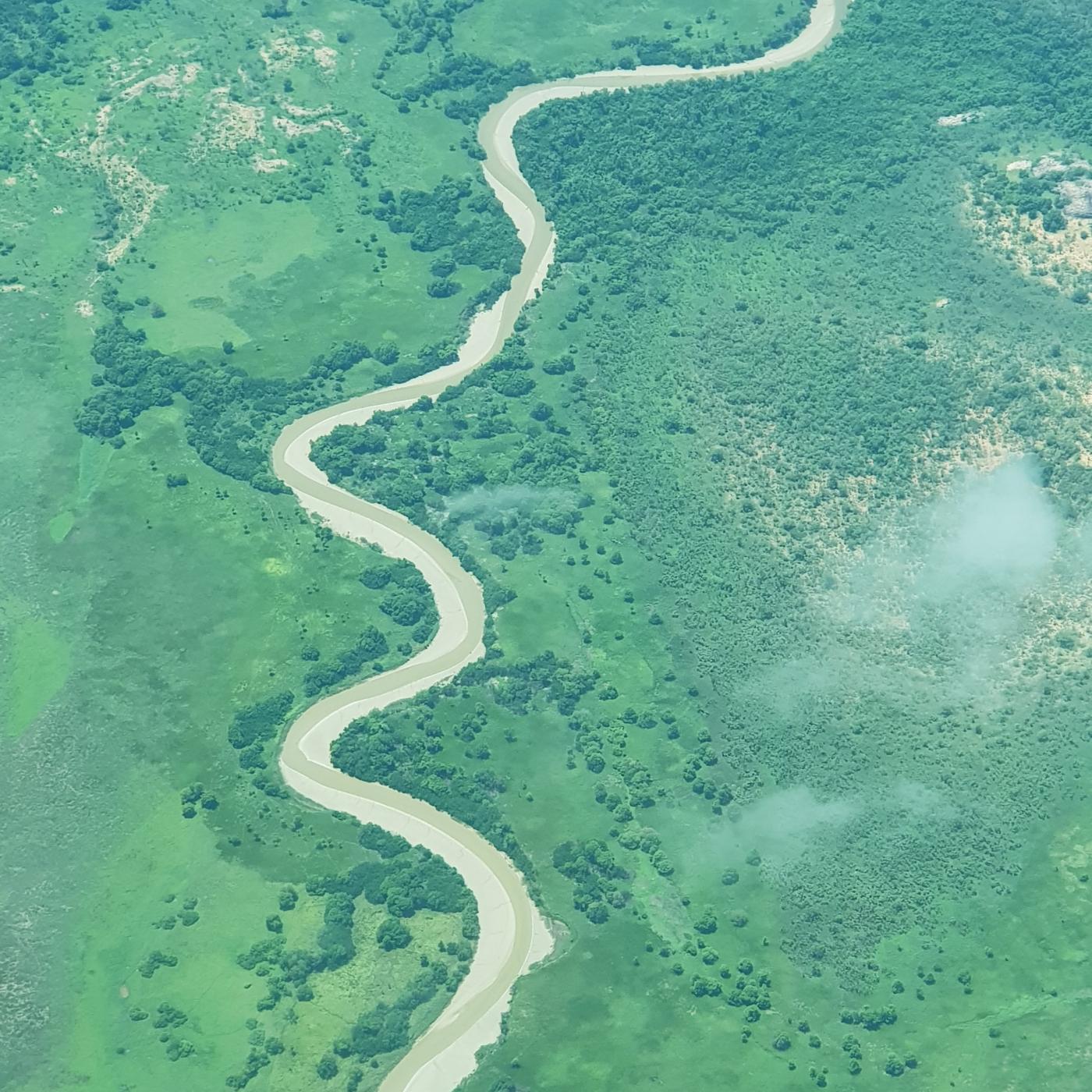 An aerial view of a river snaking through green country