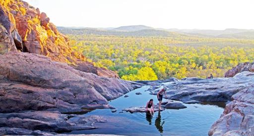 Two people swimming in the top pool at Gunlom Falls