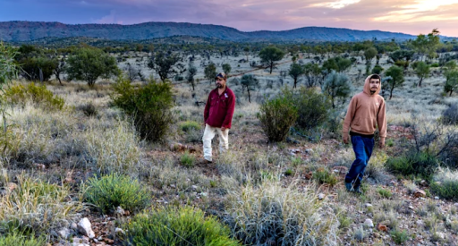 Traditional owner Damien Kunoth (Arrernte) with son Byson on country outside Alice Springs.Justin McManus